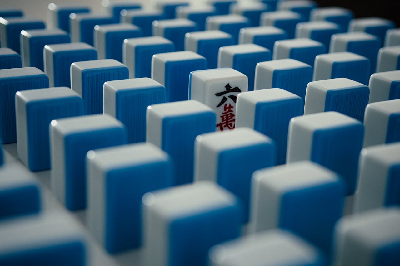 creative-03 Close-up of a pattern of blue and white Mahjong tiles arranged creatively.